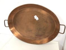A large copper oval tray with handles to sides (64cm x 43cm)