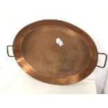 A large copper oval tray with handles to sides (64cm x 43cm)