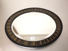 An Edwardian oval metal grained mirror with bevelled glass (51cm x 61cm)