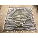 A French Connection square flatweave rug with diamond medallion within a repeating stylised leaf