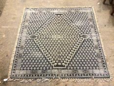 A French Connection square flatweave rug with diamond medallion within a repeating stylised leaf