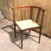 An Edwardian Georgian style corner chair with triple slat back and turned arm supports, on turned