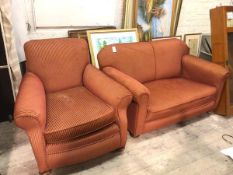 A 1920s two piece lounge suite comprising an upholstered easy chair and two seater drop end sofa