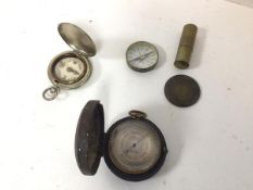 A late 19thc/early 20thc pocket barometer, in original case (3cm x 6cm) and two compasses and a tube