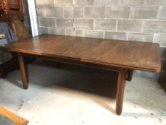 An Art Deco mahogany extending dining table, with magic leaf mechanism, on incised circular supports