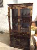 A modern Chinese display cabinet with pair of glazed doors enclosing a shelved interior, with