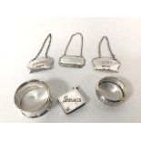 Three silver bottle labels, one Sherry, one Port and one Presentation label, two napkin rings and