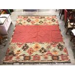 An Oka flat woven rug with carmine field, with geometric pattern borders to two sides (a/f) (305cm x