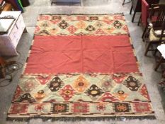 An Oka flat woven rug with carmine field, with geometric pattern borders to two sides (a/f) (305cm x