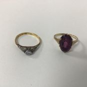 An 18ct gold ring, marked P.T. Set, with single chip diamond (O) (1.55g) and a 9ct gold amethyst set