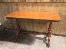 A Victorian mahogany centre table, the rectangular top on turned supports united by turned