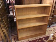 A modern open bookcase fitted three shelves, on plinth base (103cm x 95cm x 26cm)