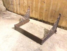 A 19thc cast iron tray rack, with pierced brackets to sides and frieze with rosettes (42cm x