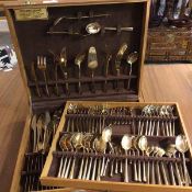 A cutlery canteen with a quantity of gilt metal flatware including knives, forks, spoons, serving