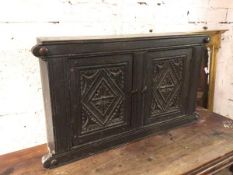 A 1920s Tudor style wall cabinet with two panelled doors enclosing a single shelf to interior (