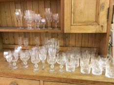 A collection of glassware including cut glass and crystal wine glasses, champagne flutes, brandy