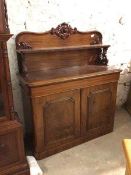 A Victorian mahogany chiffonier, the back with carved crest above a ledge supported by pierced