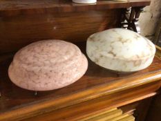 Two opaque mottled glass pendant lights, one in pink tones, the other stone effect, complete with