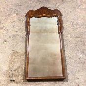 A 1930s walnut wall mirror, formerly from dressing table (94cm x 48cm)