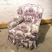 An Edwardian tub chair, with a toile de jouy loose cover over earlier upholstery (76cm x 73cm x