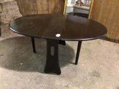 An Ercol elm drop leaf occasional table, the oval top with two drop leaves, on gateleg supports,