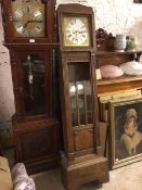 An Edwardian oak longcase clock, the metal dial with gilt corners and roman numerals, within an