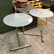 A pair of contemporary side tables, with opaque circular glass tops on metallic frames (64cm x