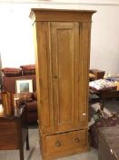 A Victorian pine wardrobe, with moulded cornice above a single door enclosing hanging space,