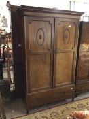 An early 20thc mahogany Georgian inspired wardrobe, the moulded cornice above two panel doors