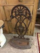 A Victorian cast metal stick stand with cornucopia pierced splat above a female portrait (rail a/