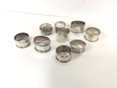 A group of nine silver napkin rings, various designs (combined: 248.85g)