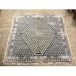 A French Connection square flatweave rug with diamond medallion within a repeating stylised leaf