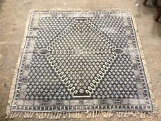 A French Connection square flatweave rug with diamond medallion within a repeating stylised leaf