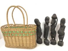 A set of four carved wood African figures (tallest: 33cm) and a two handled wicker basket (5)