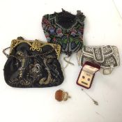 A mixed lot including two beadwork purses and another purse with gilt metal clasp, a pair of