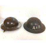 Two helmets of WWII vintage, each bearing the intials A & R one having been later painted (13cm x