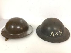 Two helmets of WWII vintage, each bearing the intials A & R one having been later painted (13cm x