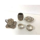 A small silver barrel inscribed Fisher, Stirling to base, two silver napkin rings and pierced