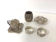 A small silver barrel inscribed Fisher, Stirling to base, two silver napkin rings and pierced