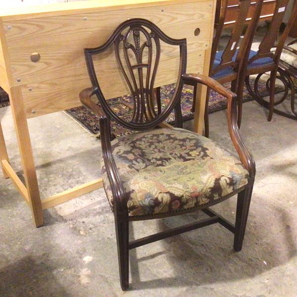 A 19thc mahogany shield back open armchair, the pierced splat with Prince of Wales feathers above an