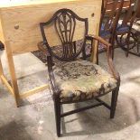 A 19thc mahogany shield back open armchair, the pierced splat with Prince of Wales feathers above an