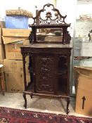 A late Victorian side cabinet, the superstructure with elaborately carved crest above a shelf and