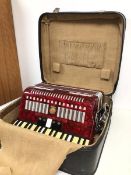 A Studio accordian in original travelling case, bears plaque Beijing and Hsinghai (case: 24cm x 50cm
