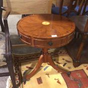 A Georgian style yew wood occasional table, the circular top with satinwood inlay, above three