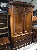 A large Victorian mahogany linen press, with moulded cornice above two panel doors, interior