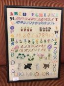 A mid 20thc sampler with Clover, Thistle, Rose and Leek (46cm x 33cm)