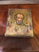A 19thc Russian icon of St Nicholas depicting head and shoulders, carrying a bible, the border
