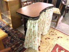 A trestle table with rounded rectangular top with a later curtain rail added, with curtain, table