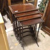 A set of four early 20thc mahogany nesting tables, the rectangular tops with raised gallery, on