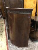 A 19thc mahogany hanging corner cabinet with dentil cornice above a blind fretwork frieze, with